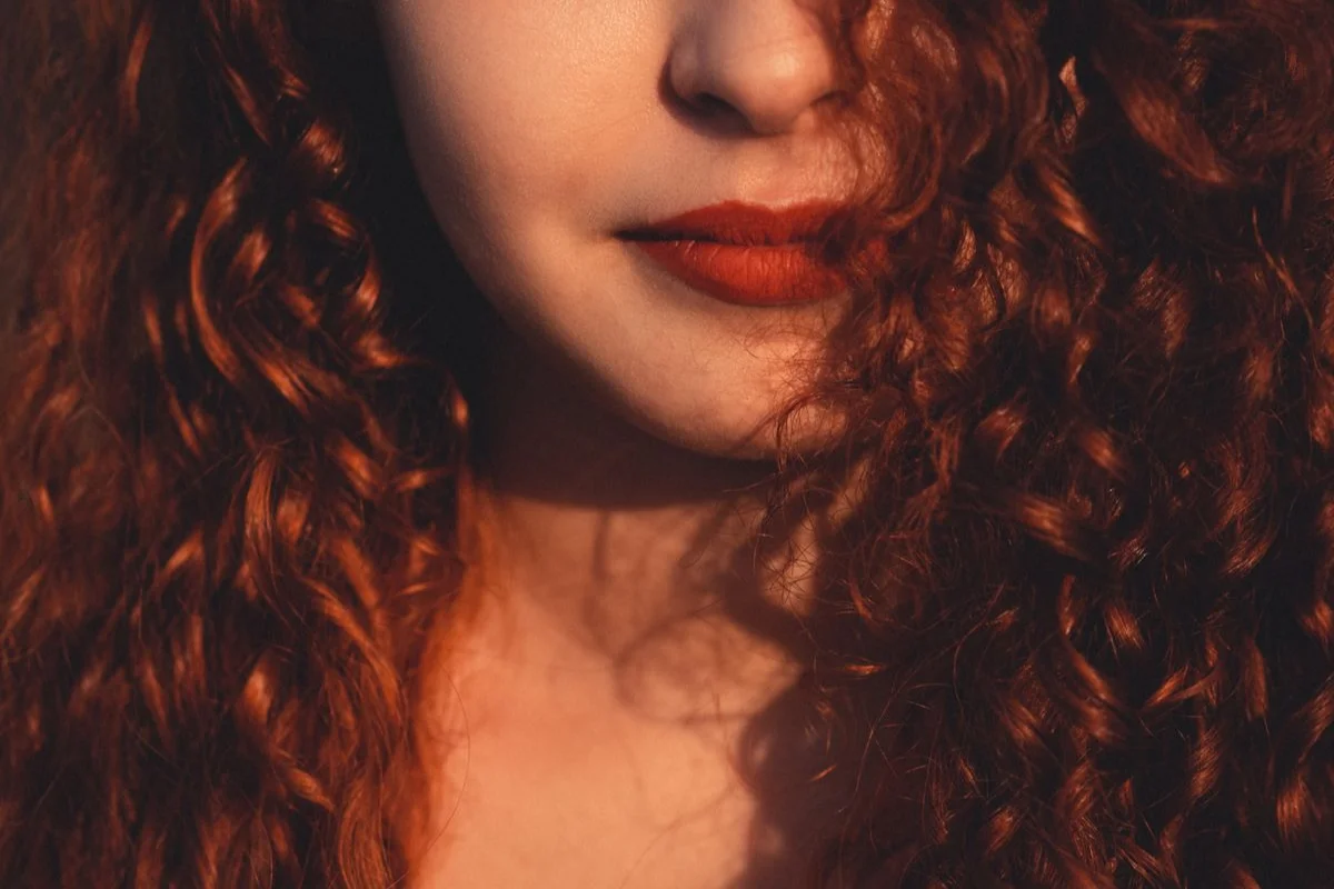 Close-up of long, voluminous red curly hair